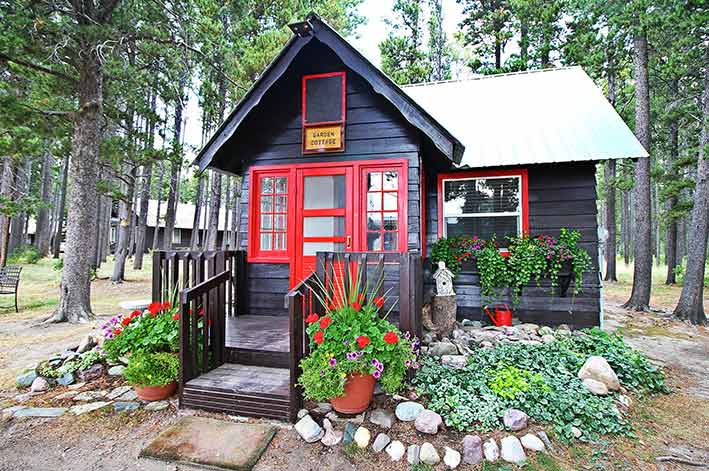 Garden cottage surrounded by flowers at Glacier Park Lodge