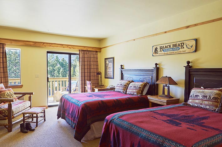 Great Bear Lodge Room at St. Mary Village featuring a private balcony and two queen beds
