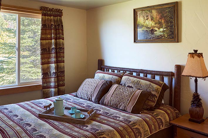 Room with one queen bed in the Glacier Cabins at St. Mary Village