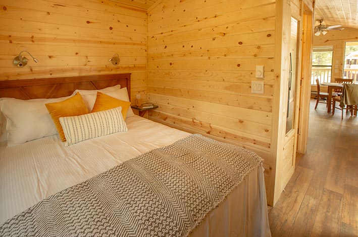 A bedroom in a wooden cabin.