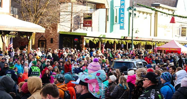 A large crowd gathers for a Winter Carnival parade.