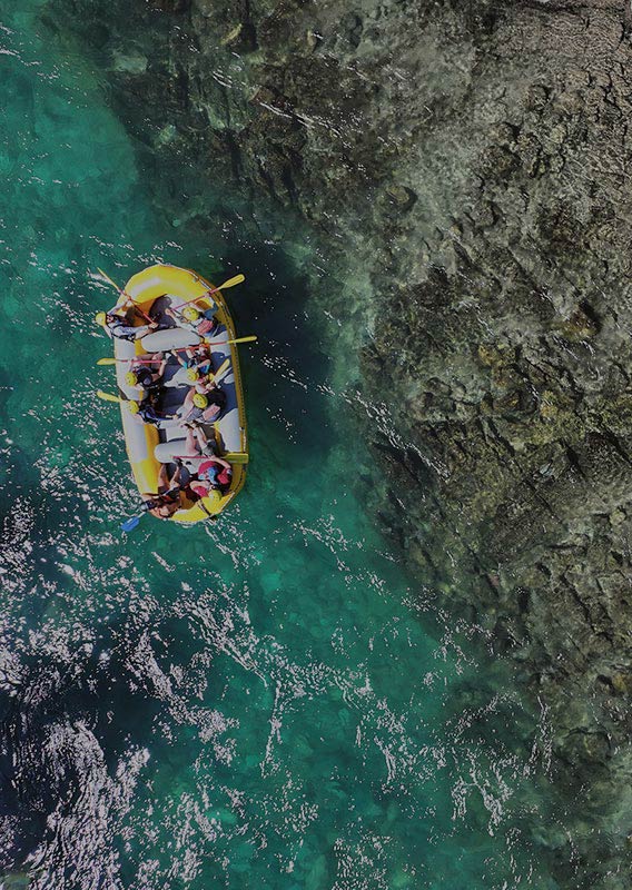 An overhead view of a raft floating down a river.