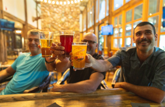 Three men cheers with their beers